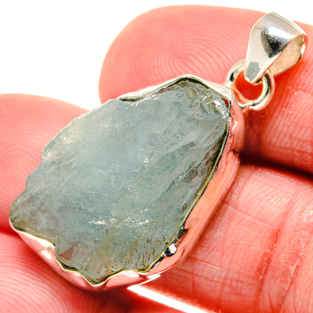 Rough aquamarine pendant with sterling silver bezel and loop bail, slate-blue stone.