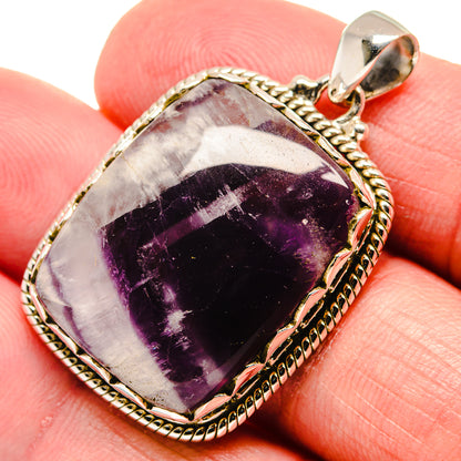 Amethyst gemstone pendant, dark purple cabochon in twisted silver rope frame