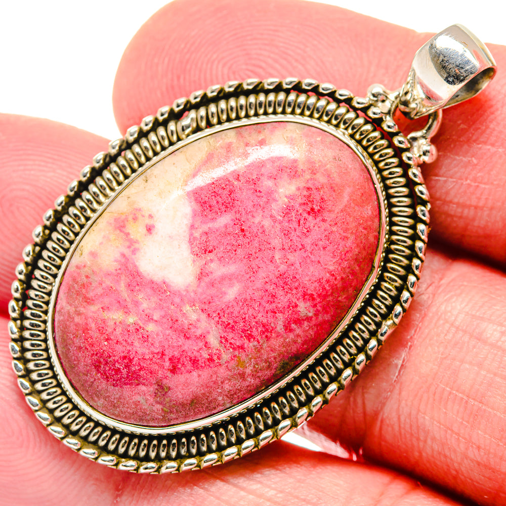Rhodochrosite pendant in 925 sterling silver with oval red stone and beaded border
