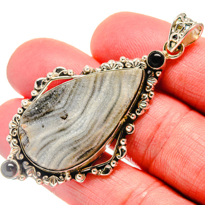 Sterling silver pendant with teardrop druzy stone and black onyx side accents