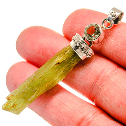 Close-up rough green crystal pendant with round green stone and textured 925 silver top