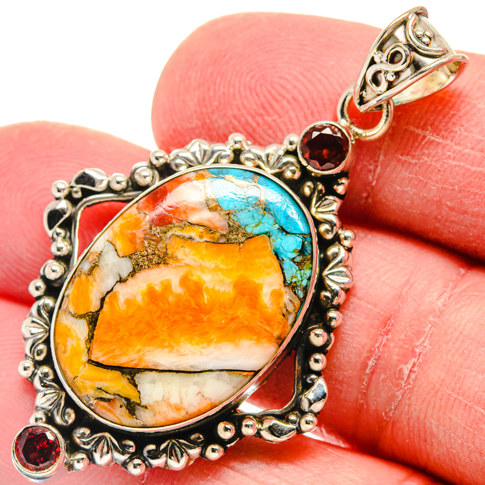 Oval turquoise amber stone pendant with garnet accents in ornate 925 silver frame