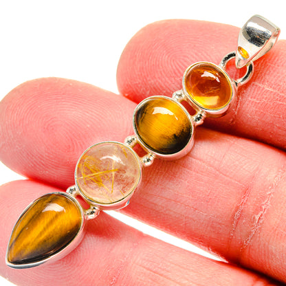 Close-up of tiger eye, amber and clear rutilated quartz sterling silver pendant