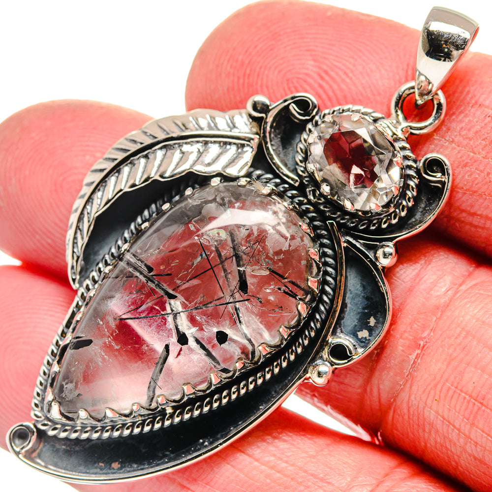 Silver-tone pendant with red oval quartz and red crystal accent in ornate frame