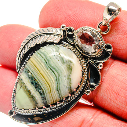 Sterling silver pendant with oval ocean jasper cabochon, red and clear crystal accents, top bail