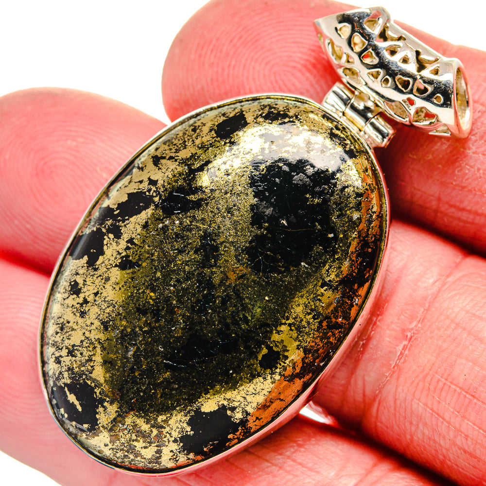 Oval black onyx pendant with gold flecks in silver-tone setting