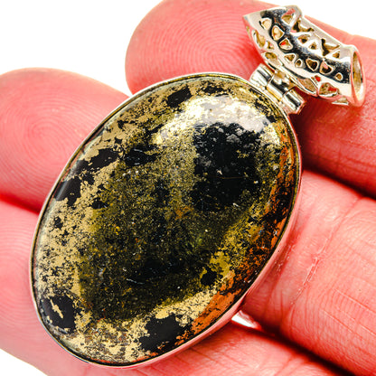 Oval black onyx pendant with gold flecks in silver-tone setting