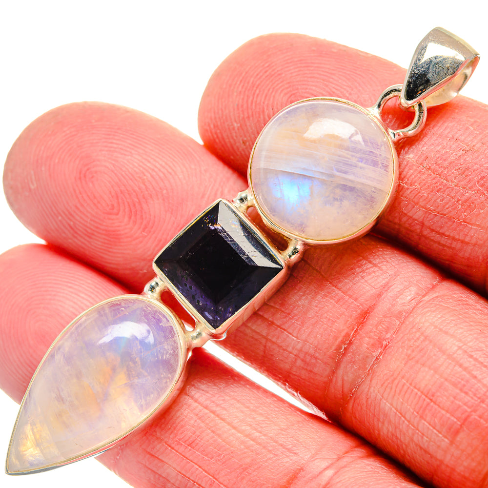 Sterling silver pendant close-up with rainbow moonstone teardrops and dark blue tanzanite