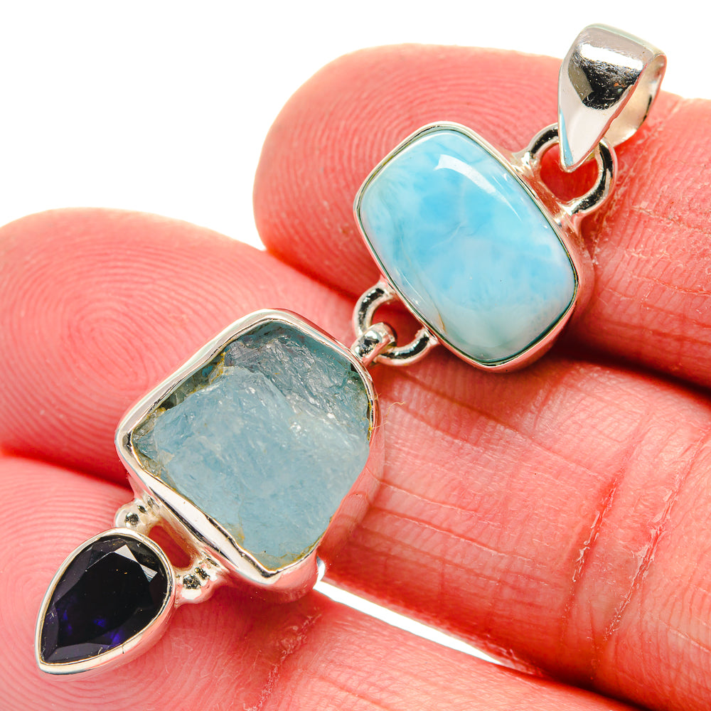 Sterling silver pendant close-up with oval light-blue stones and dark purple teardrop