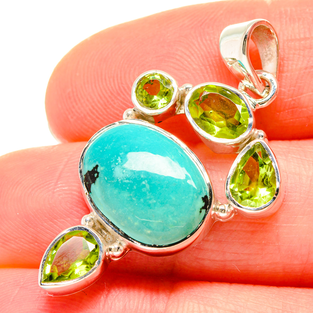 Sterling silver turquoise pendant with five peridot green stones and bail