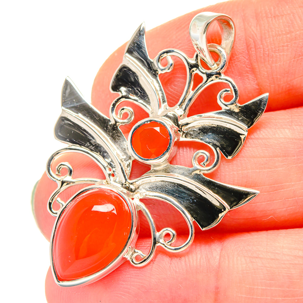 Sterling silver carnelian pendant close-up with large orange stones and open scrollwork