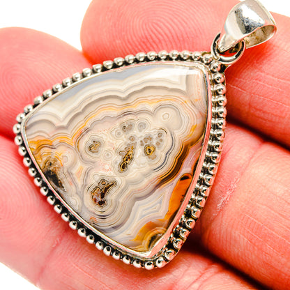 Triangular lace agate pendant, orange and cream banded stone in sterling silver frame