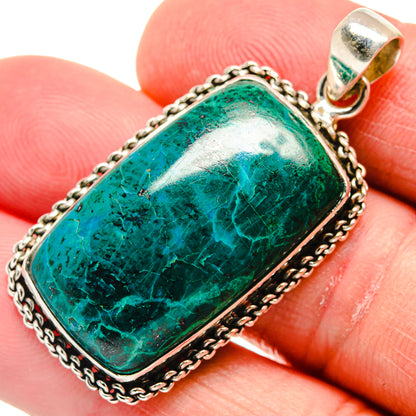 Sterling silver chrysocolla pendant with rectangular green stone bezel, bail at top