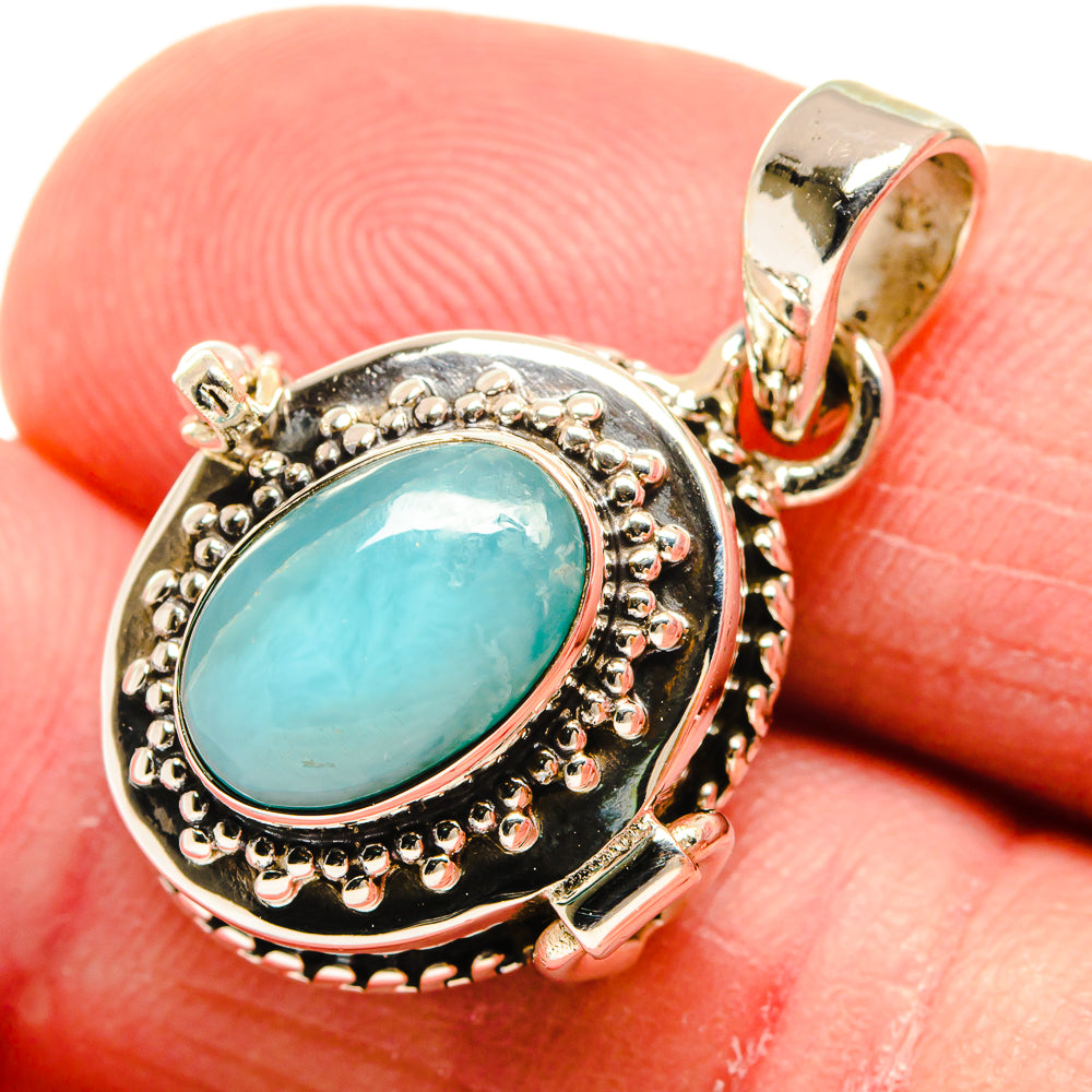 925 sterling silver pendant with oval aquamarine-colored gemstone and beaded border