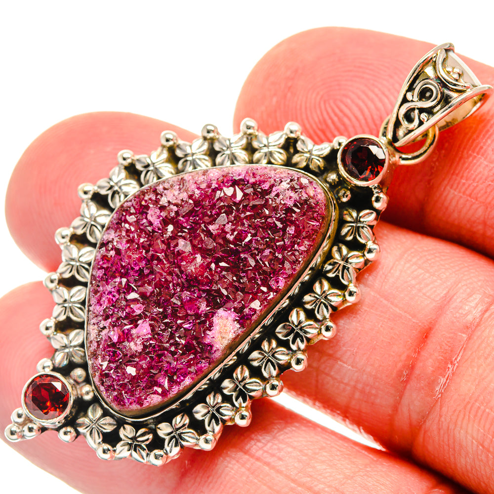 Teardrop druzy pendant in pink with ornate 925 sterling silver bezel and red garnet accents