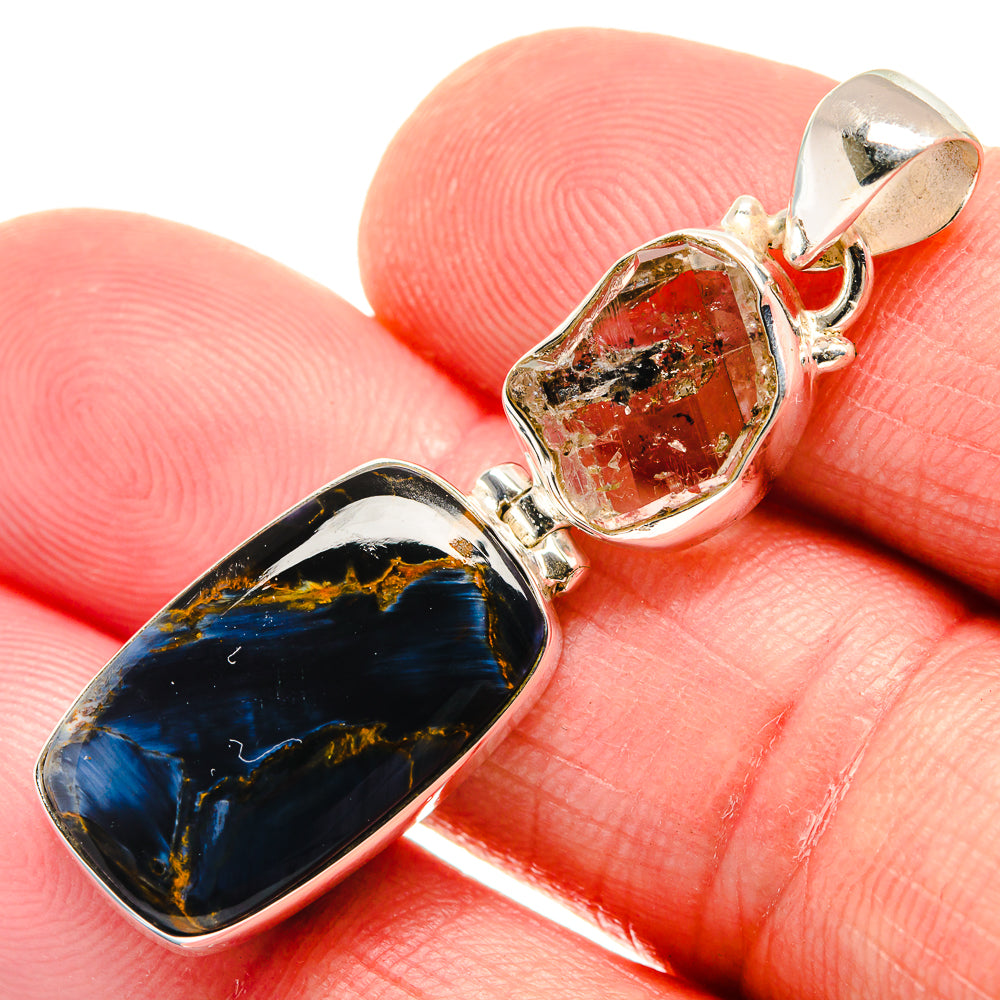 Sterling silver pendant with oval blue-and-gold stone and red flecked stone