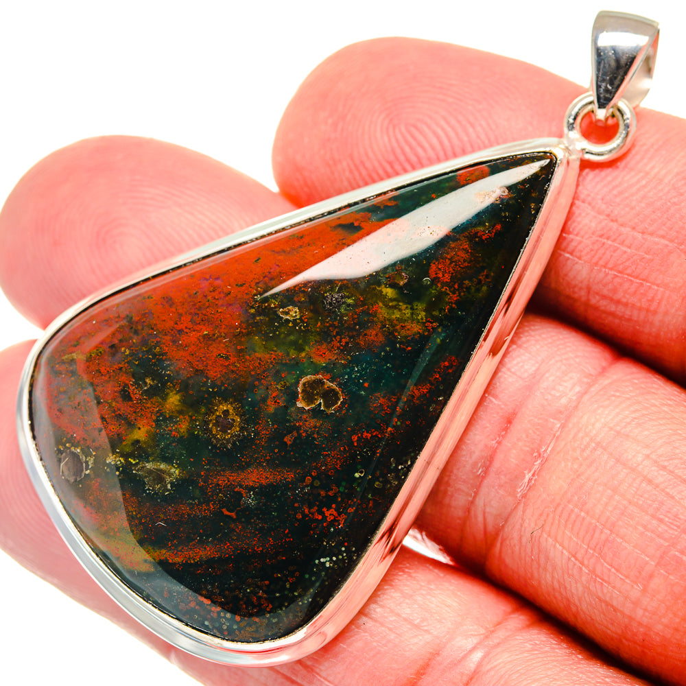 Teardrop bloodstone pendant close-up in silver bezel with red, green, and black speckles.