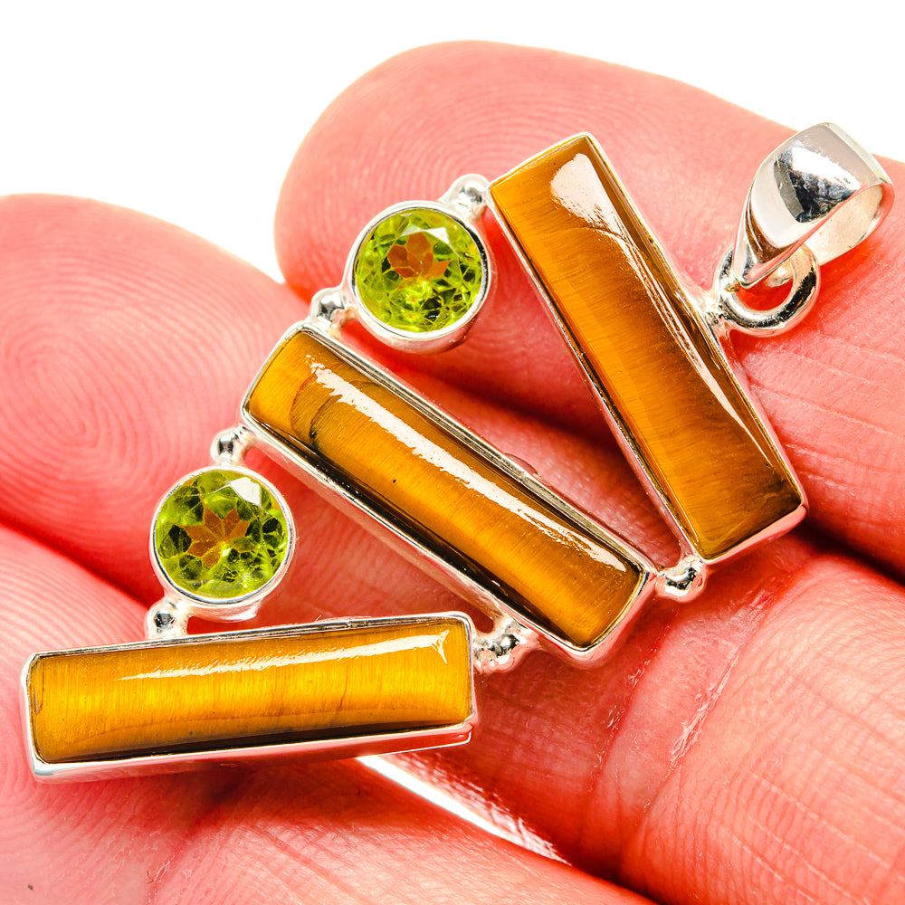 Sterling silver pendant with amber tiger eye bars and two round peridot stones