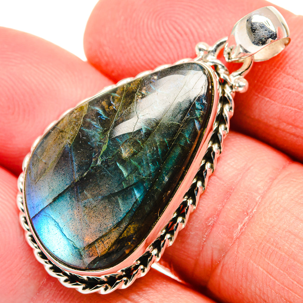 Oval labradorite sterling silver pendant with iridescent blue-green flash and ornate frame