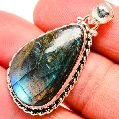 Oval labradorite sterling silver pendant with iridescent blue-green flash and ornate frame