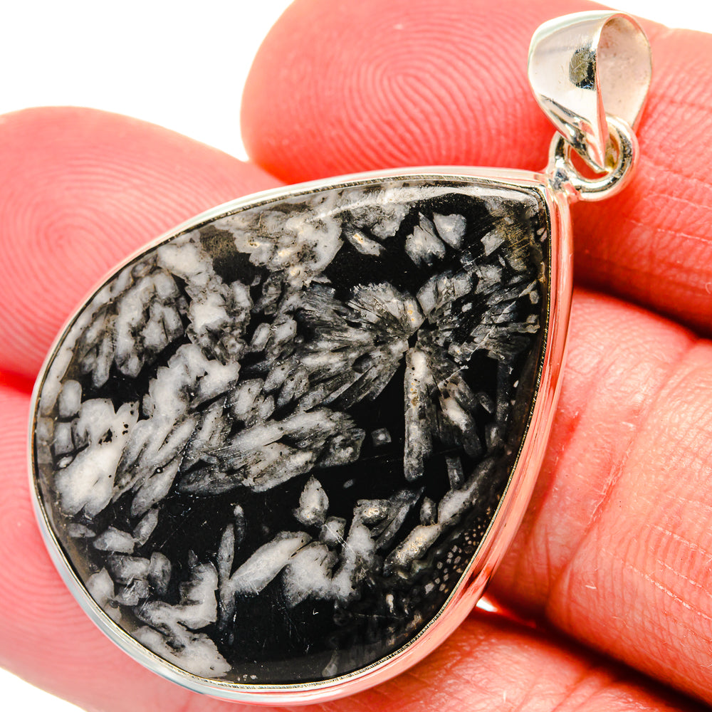 Chrysanthemum stone pendant with teardrop cabochon, black and white speckled, silver bail