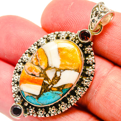 Oval mosaic stone pendant with turquoise and orange accents, set in silver with dark red gems