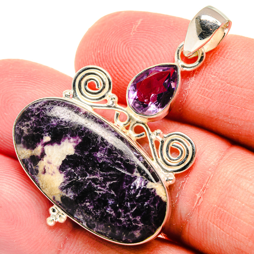 Sterling silver amethyst pendant closeup with oval cabochon and teardrop crystal top