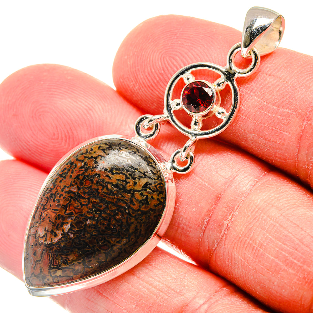 Oval dinosaur bone-pattern pendant with round red garnet, 925 sterling silver close-up