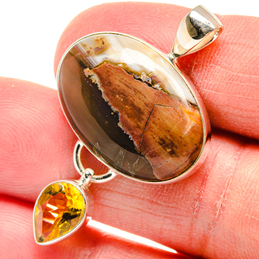 Pendant: Oval butterfly jasper cabochon with citrine teardrop and 925 silver bail on finger