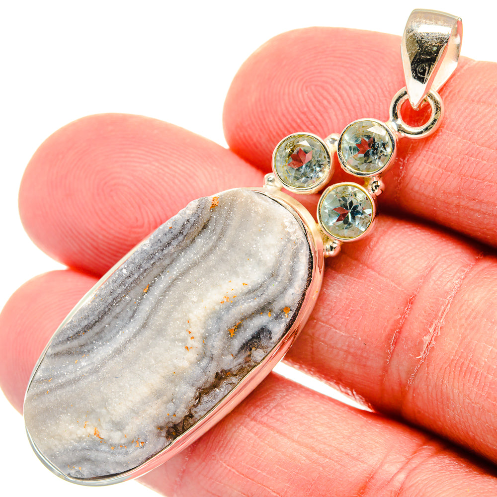 Sterling silver pendant with oval desert druzy stone and three round blue topaz accents