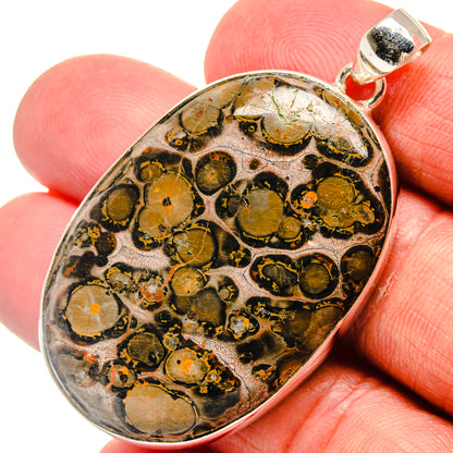 Oval Poppy Jasper pendant with gold-and-black stone, 925 sterling silver bezel and bail.