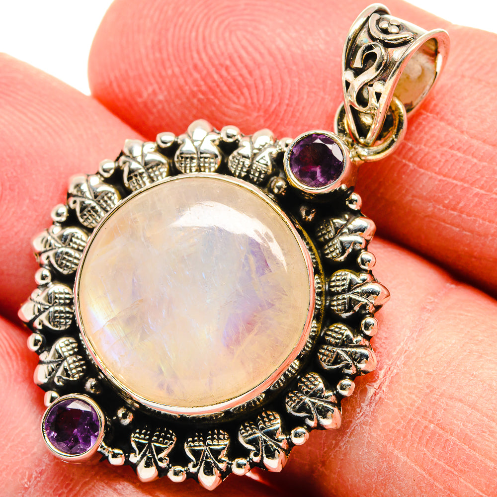 Round moonstone pendant with black filigree frame, purple amethyst side stones, bail
