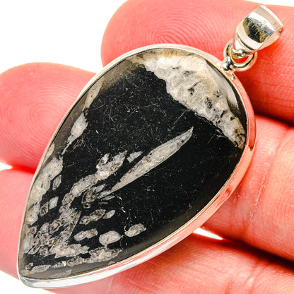 Teardrop stone pendant with black surface and silver-tone bezel, 925 sterling silver bail
