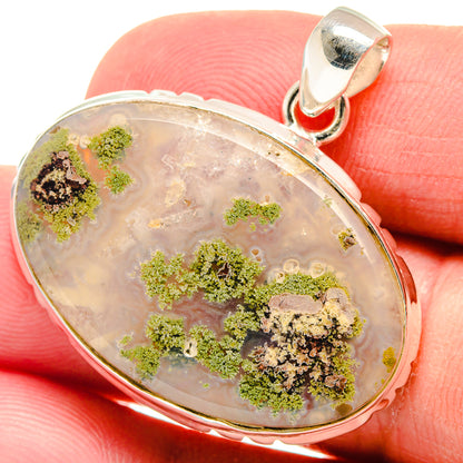 Oval plume agate pendant in polished 925 sterling silver with green dendrites