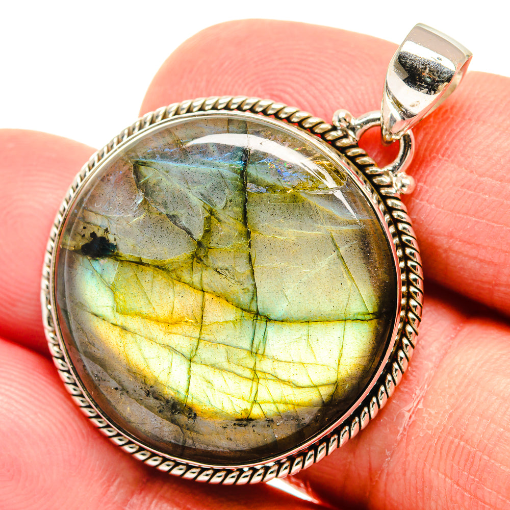 Round labradorite pendant with green-gold shimmer, oval silver bezel and hinged bail