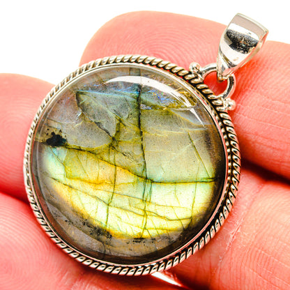 Round labradorite pendant with green-gold shimmer, oval silver bezel and hinged bail