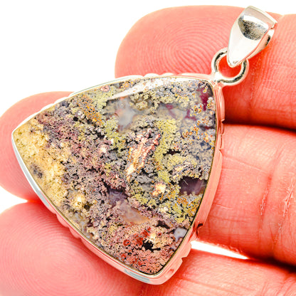 Close-up triangular plume agate pendant with silver bail, purple-gray and golden flecks