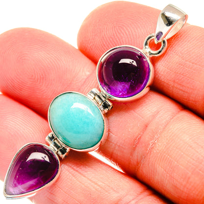 Three-stone sterling silver pendant with purple amethyst and teal larimar cabochons