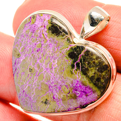 Sterling silver heart pendant with purple druzy front and top loop/bail, on finger