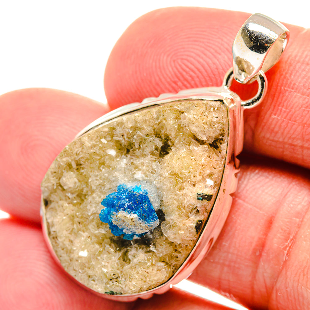 Close-up teardrop cavansite crystal pendant with vivid blue cluster in silver setting