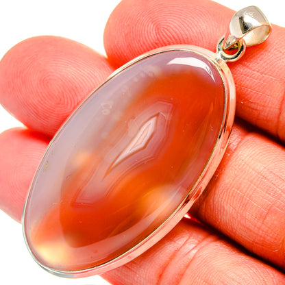 Oval orange Botswana agate pendant in 925 sterling silver bezel and bail.