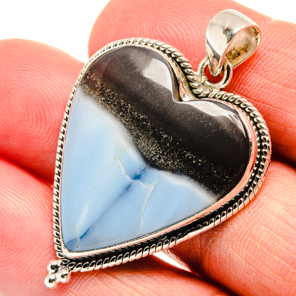 Heart-shaped opal pendant in sterling silver with dark brown and light blue stone