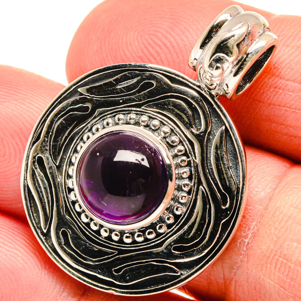 Amethyst pendant with round blackened sterling silver frame, purple gemstone, and top loop