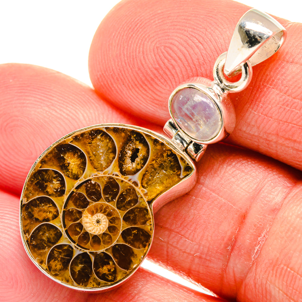 Close-up: sterling silver teardrop ammonite pendant with opal cabochon and golden fossil