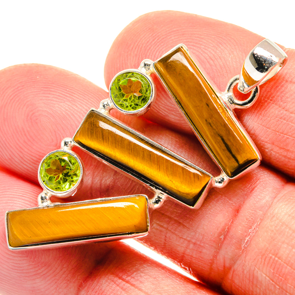 Amber tiger eye and green peridot pendant with sterling silver settings, close-up view