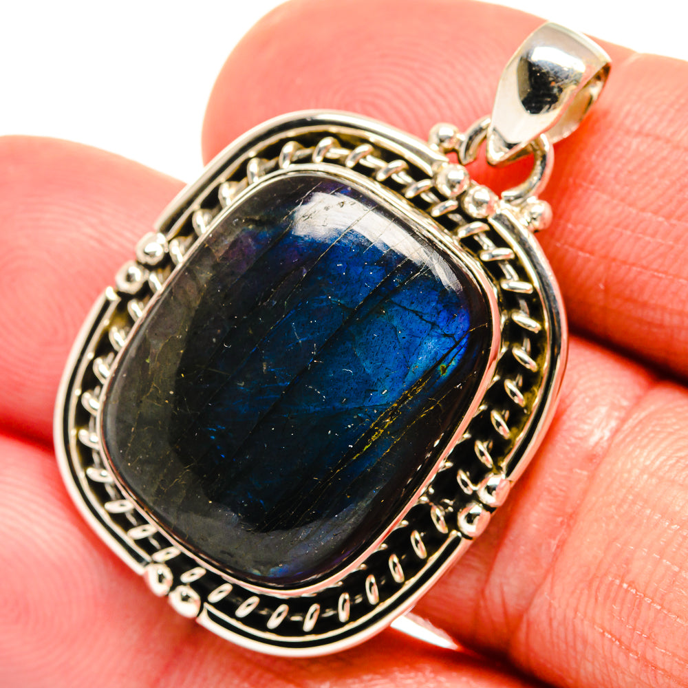 Oval labradorite gemstone pendant with blue flash, ornate silver frame and bail