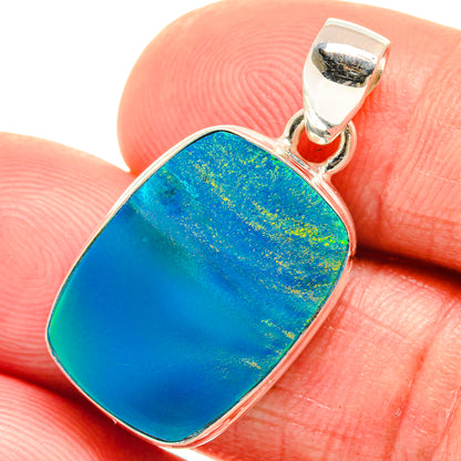 Blue opal pendant in sterling silver bezel with bail, oval cushion shape