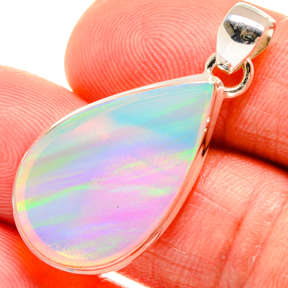 Teardrop opal pendant with prong-set iridescent stone and silver bail