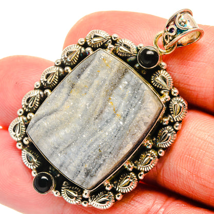 Rectangular druzy pendant with black onyx beads in detailed gold-tone filigree border