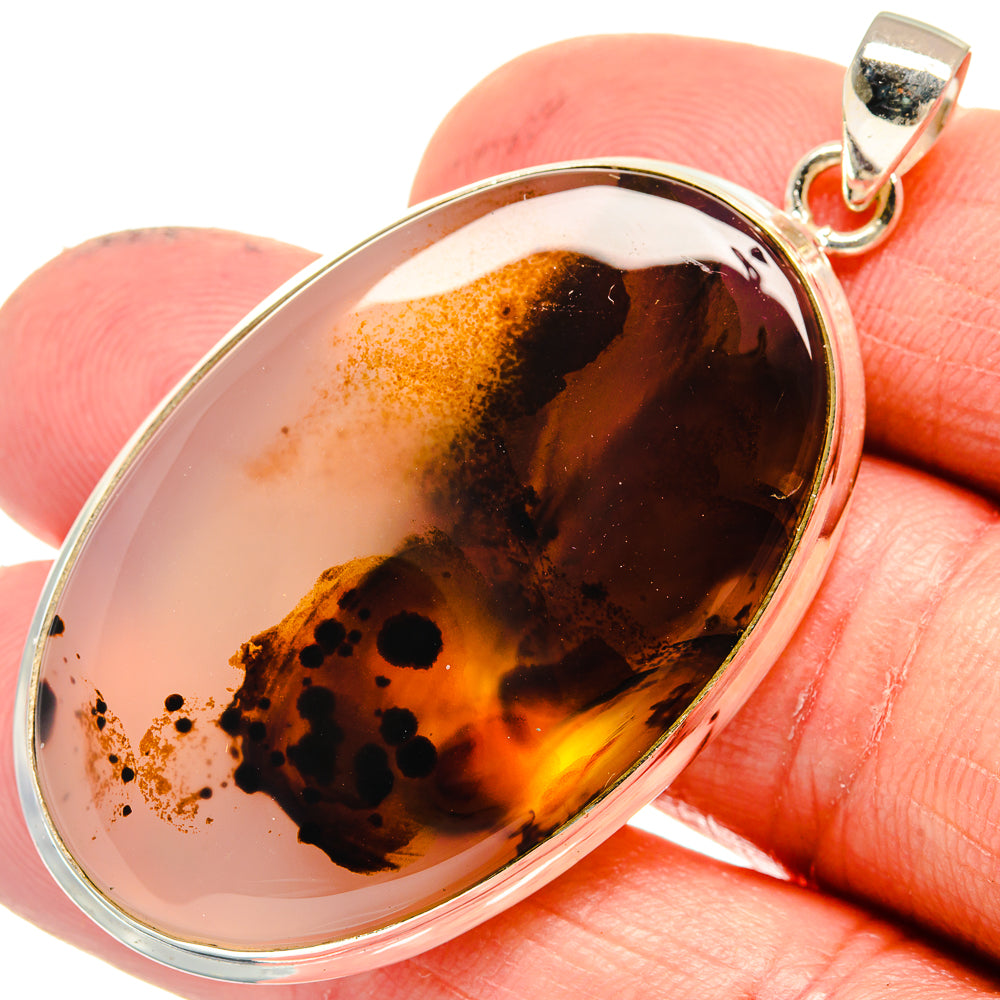 Amber and black agate pendant in polished 925 silver bezel with hinged bail
